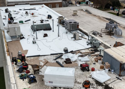 A construction site on a roof, featuring an array of equipment and tools, highlighting the active development phase